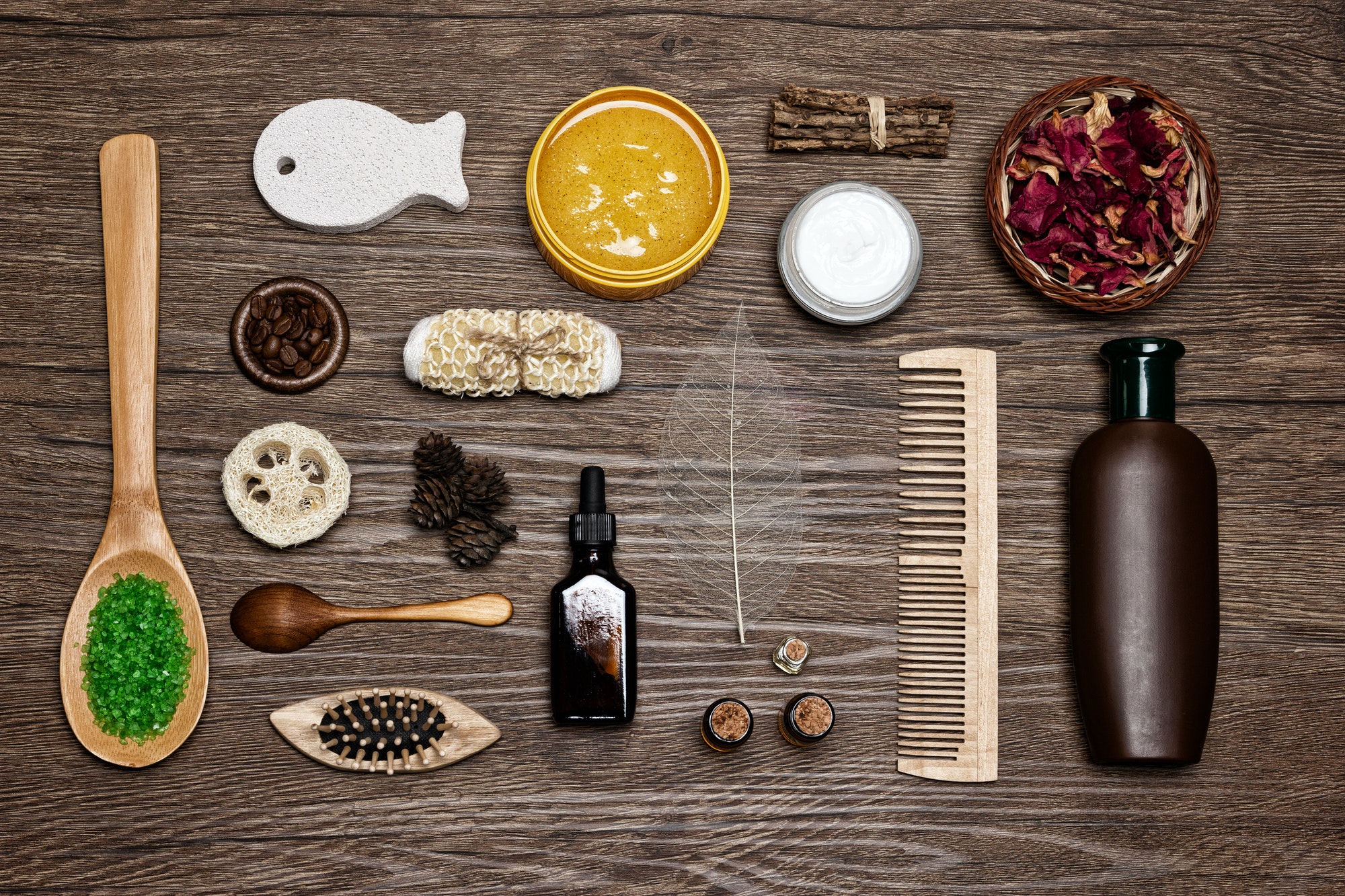 Natural body and hair care cosmetics on wood background